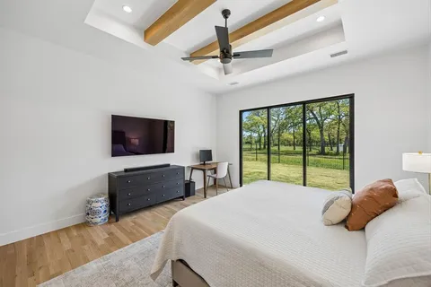 a bedroom with a large bed and a flat screen tv