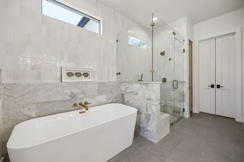 a bathroom with a bathtub and shower