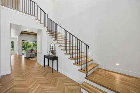 a view of entryway and hall with wooden floor
