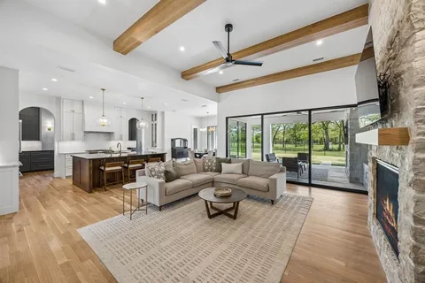 a living room with furniture fireplace and flat screen tv