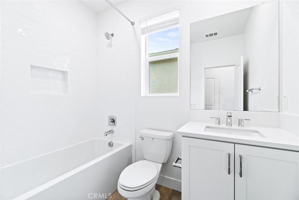 374 Baluster Irvine, CA 92618 - Photo 33 of 64 a bathroom with a toilet a sink a mirror a bathtub and vanity