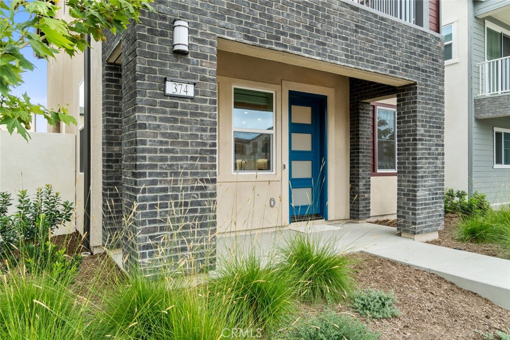 374 Baluster Irvine, CA 92618 - Photo 40 of 64 a view of a brick house with plants and large trees