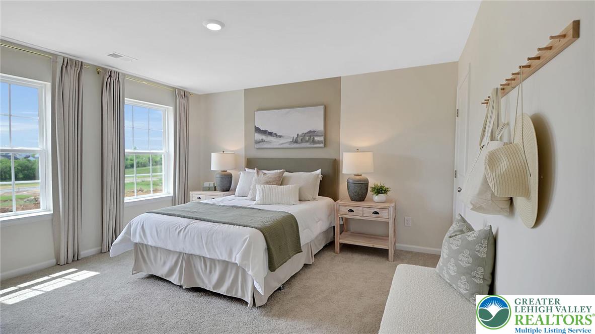 109 Winding Road Easton, PA 18040 - Photo 17 of 29 a spacious bedroom with a bed and a painting on the wall