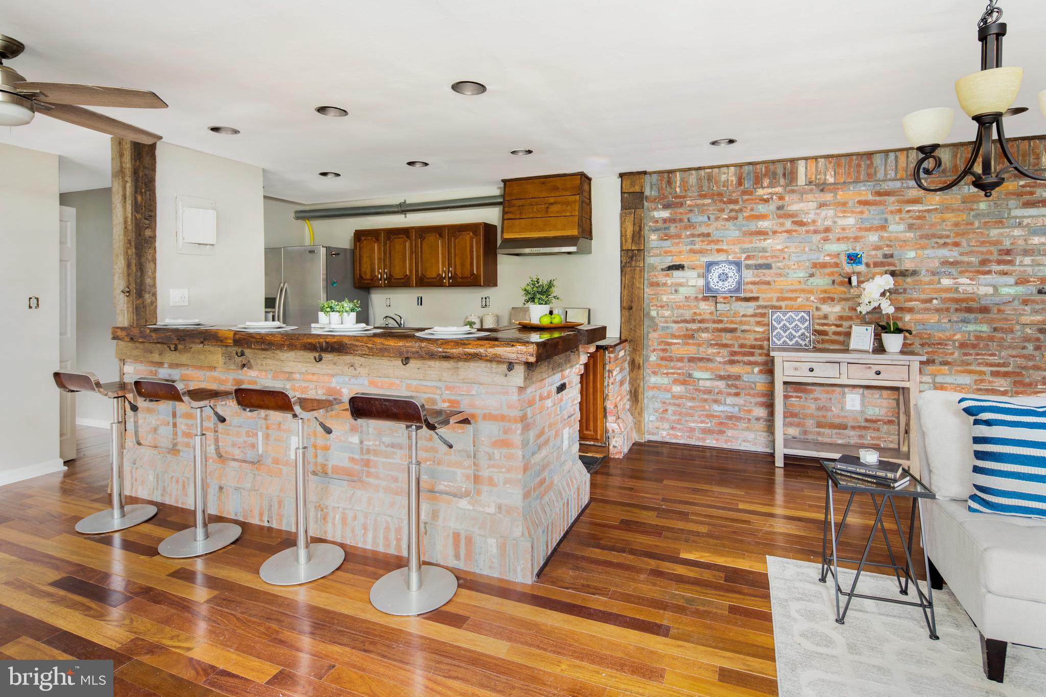 9274 Adelphi Road, Unit 12 Hyattsville, MD 20783 - Photo 4 of 16 The bar features historic home reclaimed wood