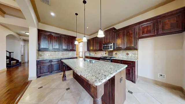 a kitchen with a counter top space a sink and appliances
