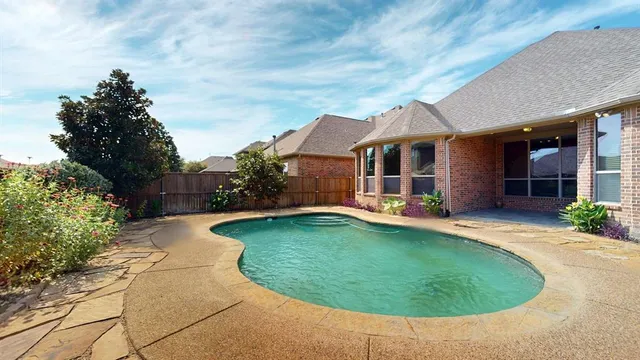 a swimming pool with outdoor seating and yard