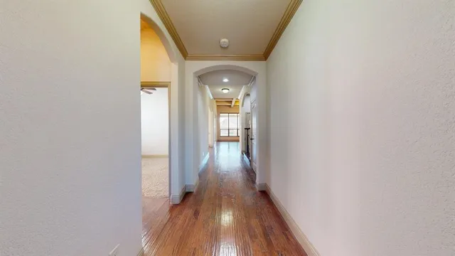 a view of staircase with wooden floor and fan