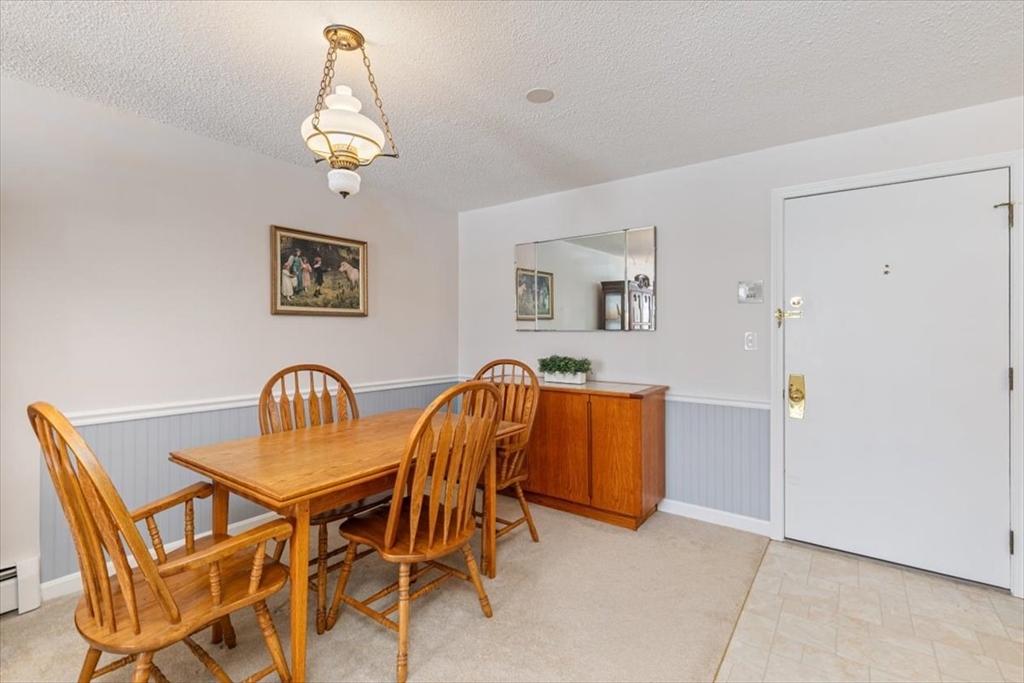 42 Main Street, Unit 22 North Reading, MA 01864 - Photo 11 of 37 a dining room with furniture and chandelier