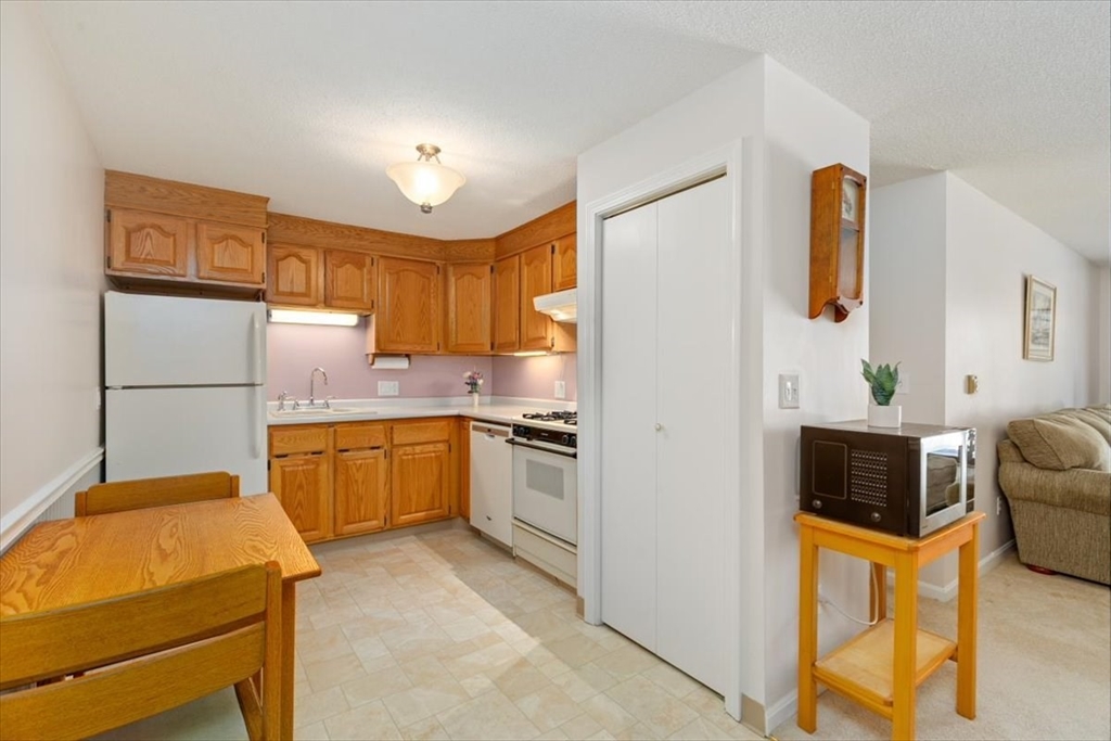 42 Main Street, Unit 22 North Reading, MA 01864 - Photo 13 of 37 a kitchen with stainless steel appliances granite countertop a refrigerator sink and microwave