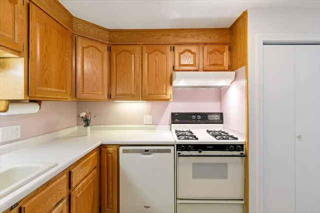 a kitchen with stainless steel appliances a stove a microwave and cabinets