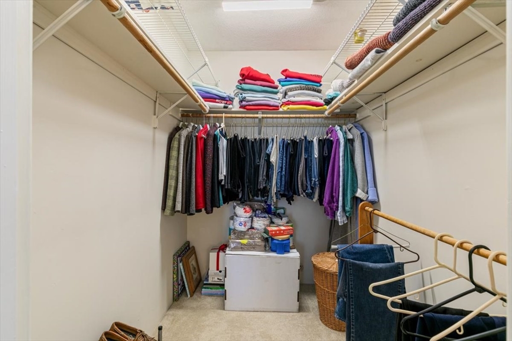 42 Main Street, Unit 22 North Reading, MA 01864 - Photo 23 of 37 a view of walk in closet with clothes and shoes