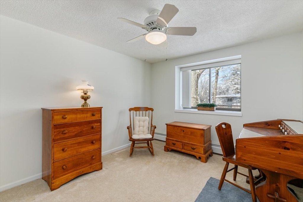 42 Main Street, Unit 22 North Reading, MA 01864 - Photo 26 of 37 a bedroom with furniture and a window