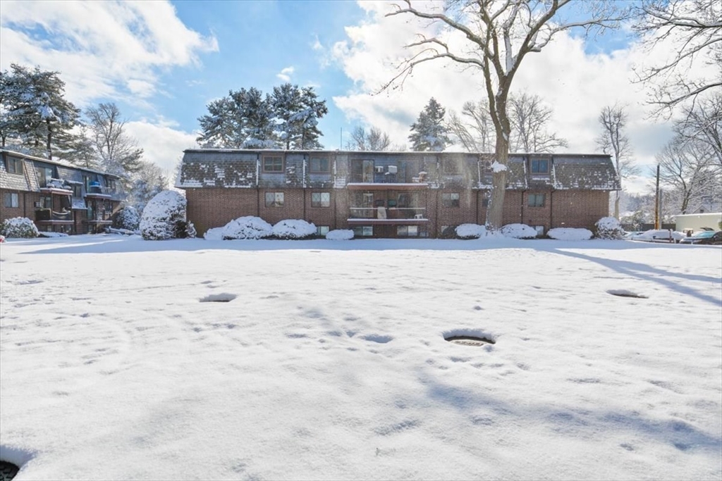 42 Main Street, Unit 22 North Reading, MA 01864 - Photo 3 of 37 a view of a yard covered in snow