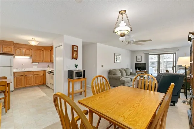 a view of a dining room with furniture and chandelier