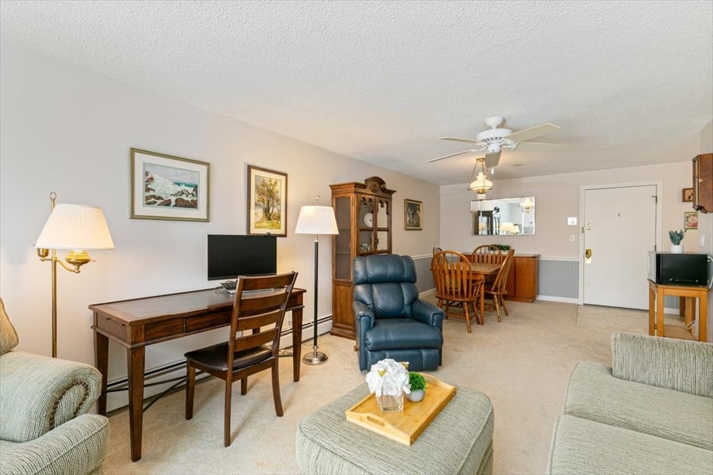 42 Main Street, Unit 22 North Reading, MA 01864 - Photo 9 of 37 a living room with furniture a rug and a window