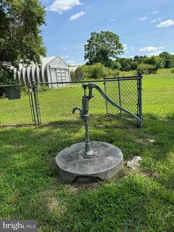 a swimming pool with lots of plants and trees