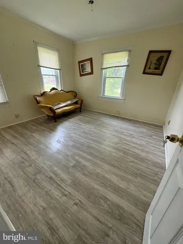 a living room with a bed furniture and a window