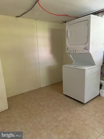 a view of a room with wooden floor and cabinet