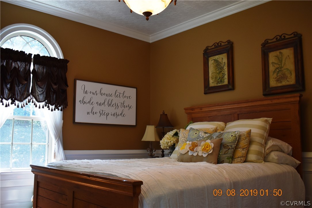 872 Wilson Road Wilsons, VA 23894 - Photo 12 of 34 a bed sitting in a bedroom next to a window