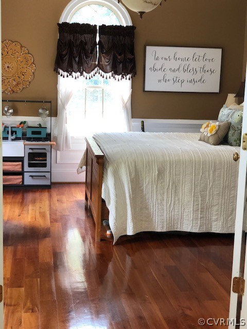 872 Wilson Road Wilsons, VA 23894 - Photo 13 of 34 a bedroom with a bed and wooden floor