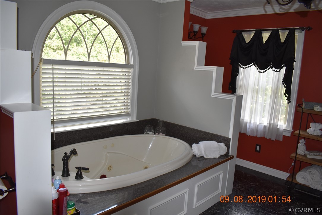 872 Wilson Road Wilsons, VA 23894 - Photo 19 of 34 a bathroom with a bathtub and a window