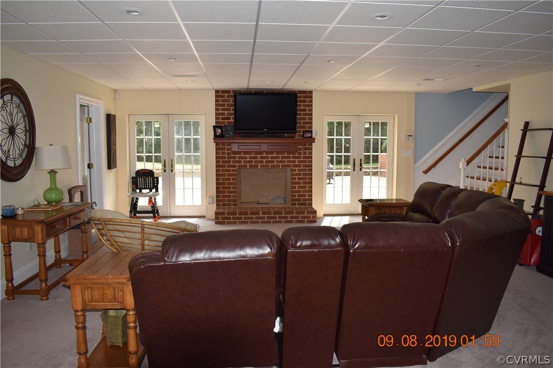 872 Wilson Road Wilsons, VA 23894 - Photo 28 of 34 a living room with furniture a fireplace and a flat screen tv