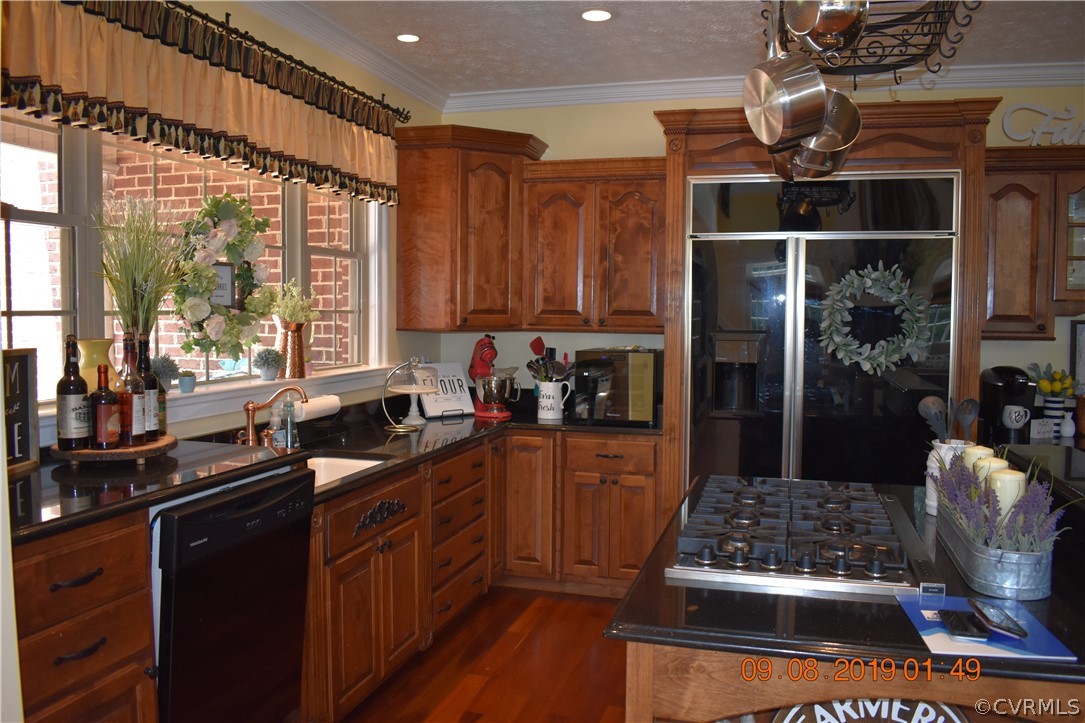 872 Wilson Road Wilsons, VA 23894 - Photo 8 of 34 a kitchen with stainless steel appliances granite countertop a stove a sink dishwasher and a refrigerator