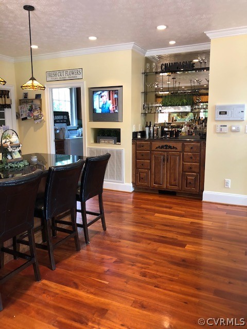 872 Wilson Road Wilsons, VA 23894 - Photo 10 of 34 a open kitchen with stainless steel appliances granite countertop a stove a refrigerator a kitchen island a dining table and chairs with wooden floor