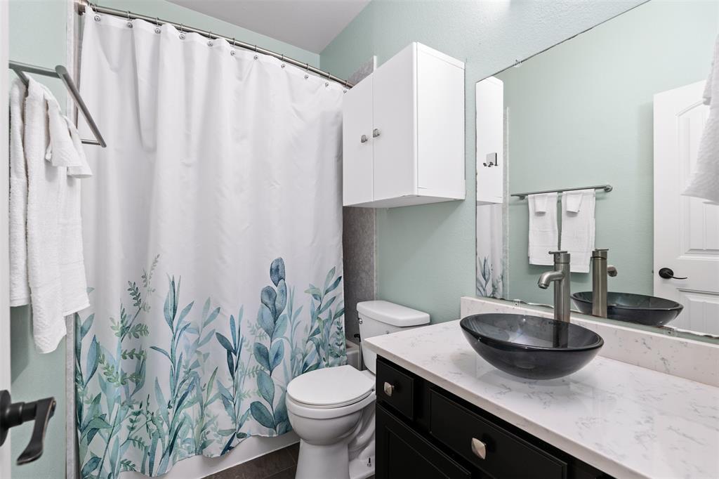 5412 Conch Train Road McKinney, TX 75070 - Photo 12 of 21 a bathroom with a granite countertop sink and a mirror