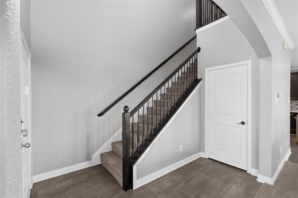 5412 Conch Train Road McKinney, TX 75070 - Photo 14 of 21 a view of staircase with wooden floor and white walls