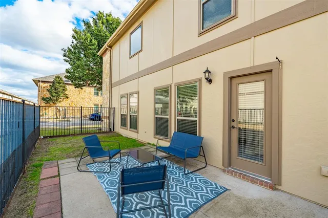 a view of a chair and tables back yard of the house