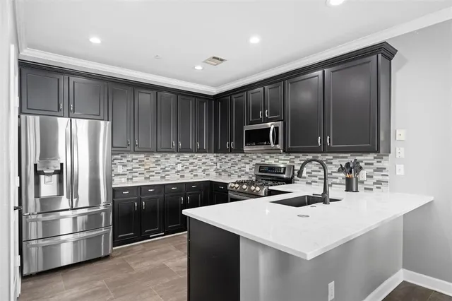 a kitchen with kitchen island stainless steel appliances and sink