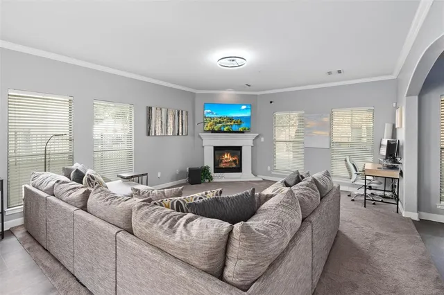 a living room with furniture fireplace and a flat screen tv