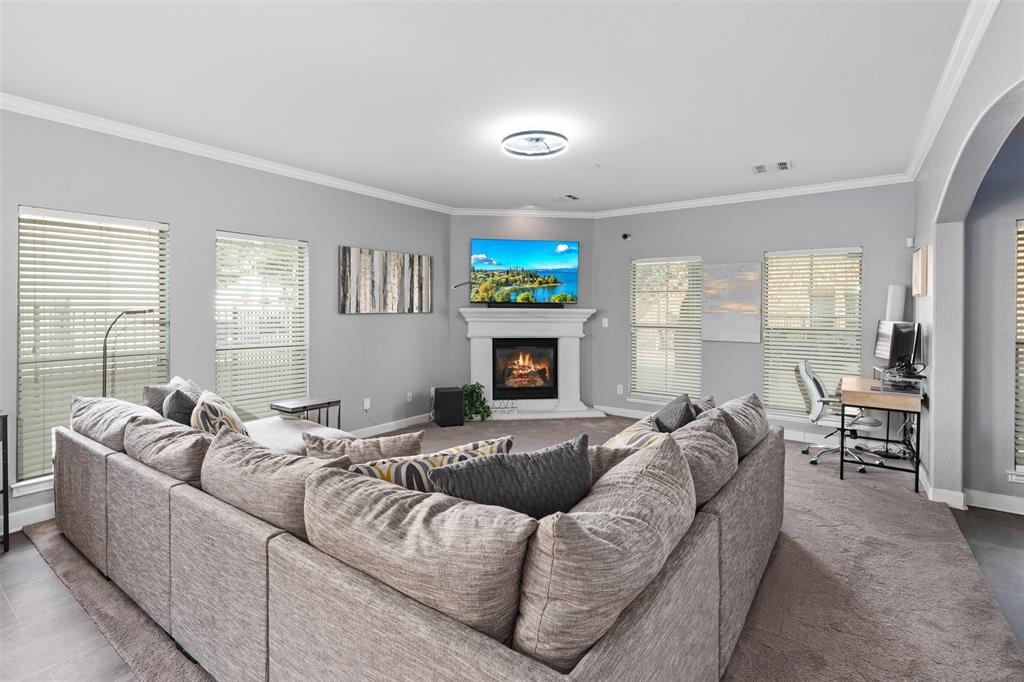 5412 Conch Train Road McKinney, TX 75070 - Photo 4 of 21 a living room with furniture fireplace and a flat screen tv