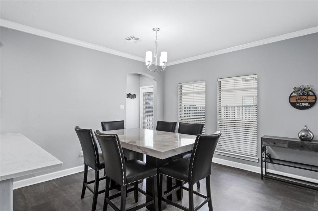 5412 Conch Train Road McKinney, TX 75070 - Photo 6 of 21 a view of a dining room with furniture and wooden floor