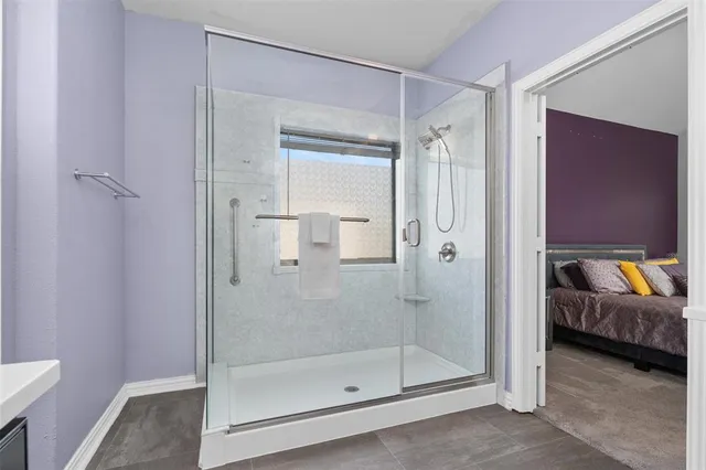a bathroom with a glass shower door