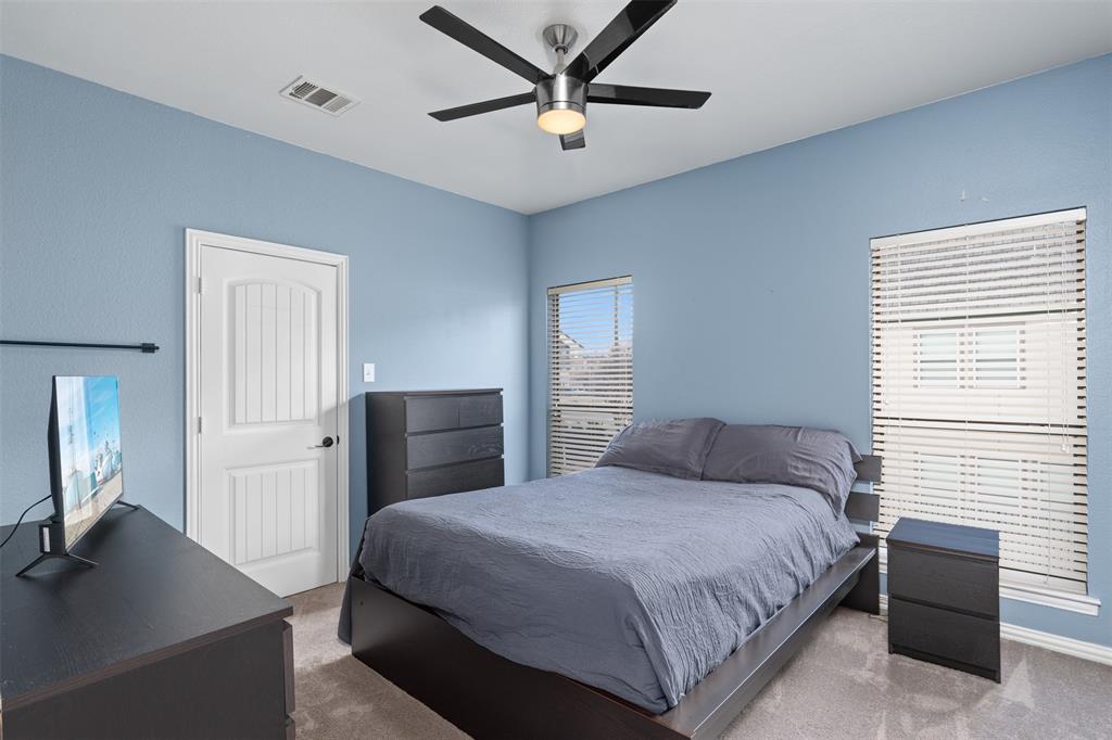 5412 Conch Train Road McKinney, TX 75070 - Photo 10 of 21 a bedroom with a bed and a flat screen tv