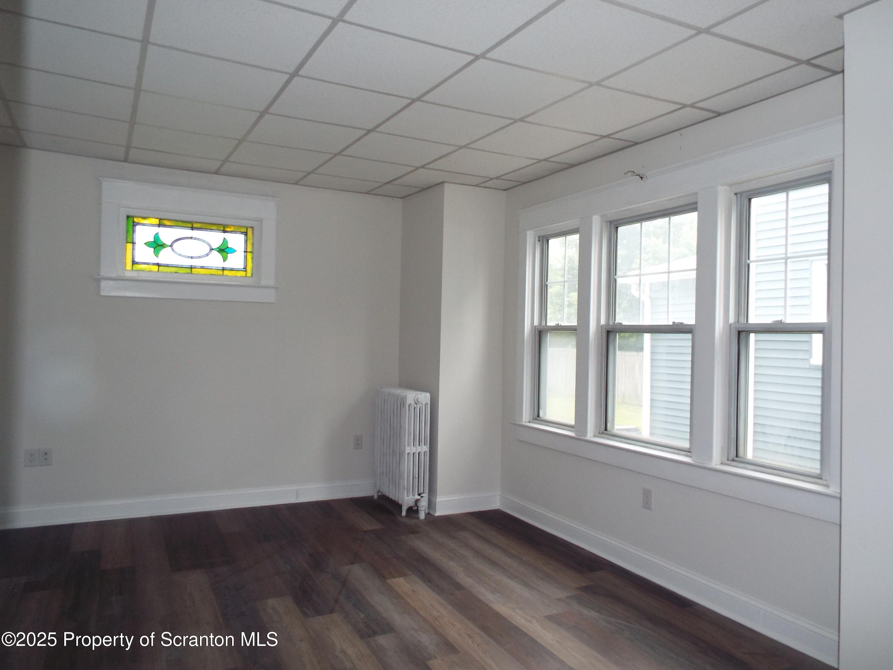 164 Welles Street Forty Fort, PA 18704 - Photo 12 of 25 a view of an empty room with a window and wooden floor