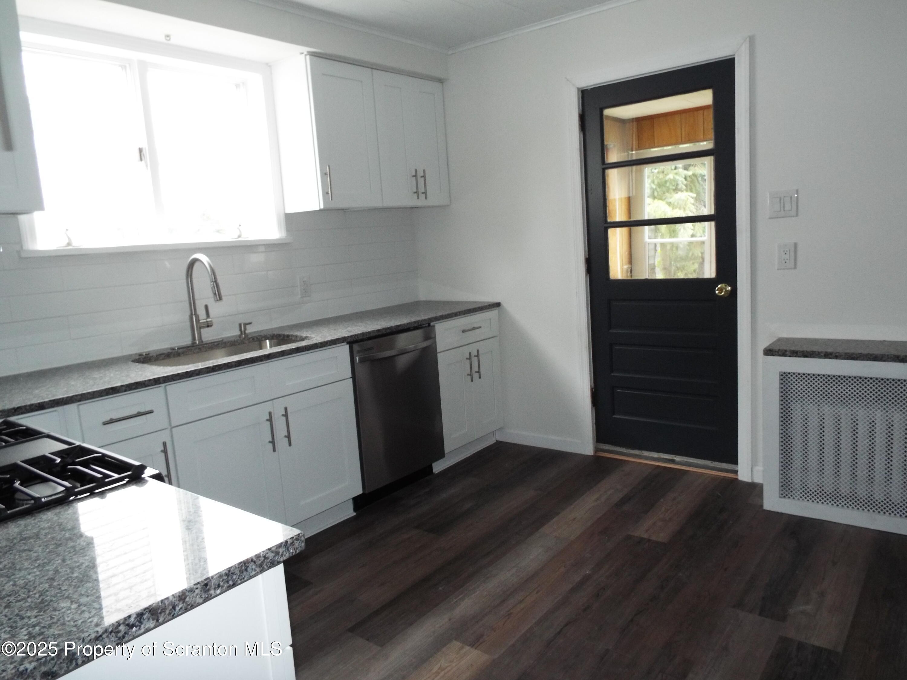 164 Welles Street Forty Fort, PA 18704 - Photo 17 of 25 a kitchen with a sink wooden floor and a window