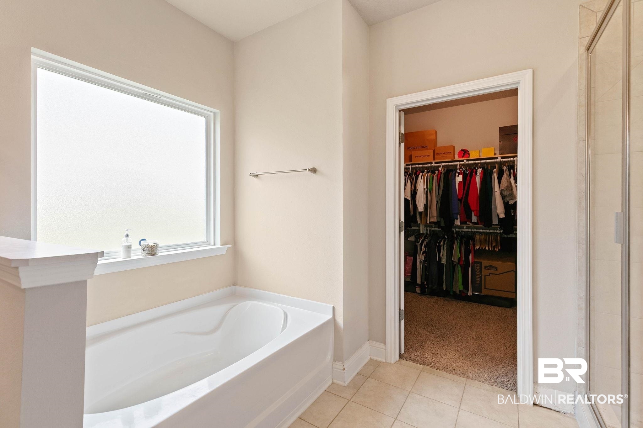 12750 B Jenkins Pit Road Daphne, AL 36527 - Photo 37 of 89 Bathroom with a spacious closet, a stall shower, light colored carpet, a bath, and light tile patterned floors