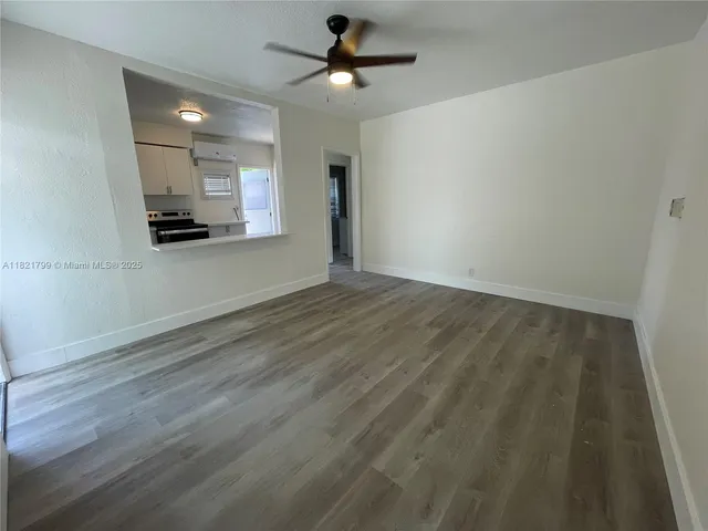 an empty room with a empty space and a ceiling fan
