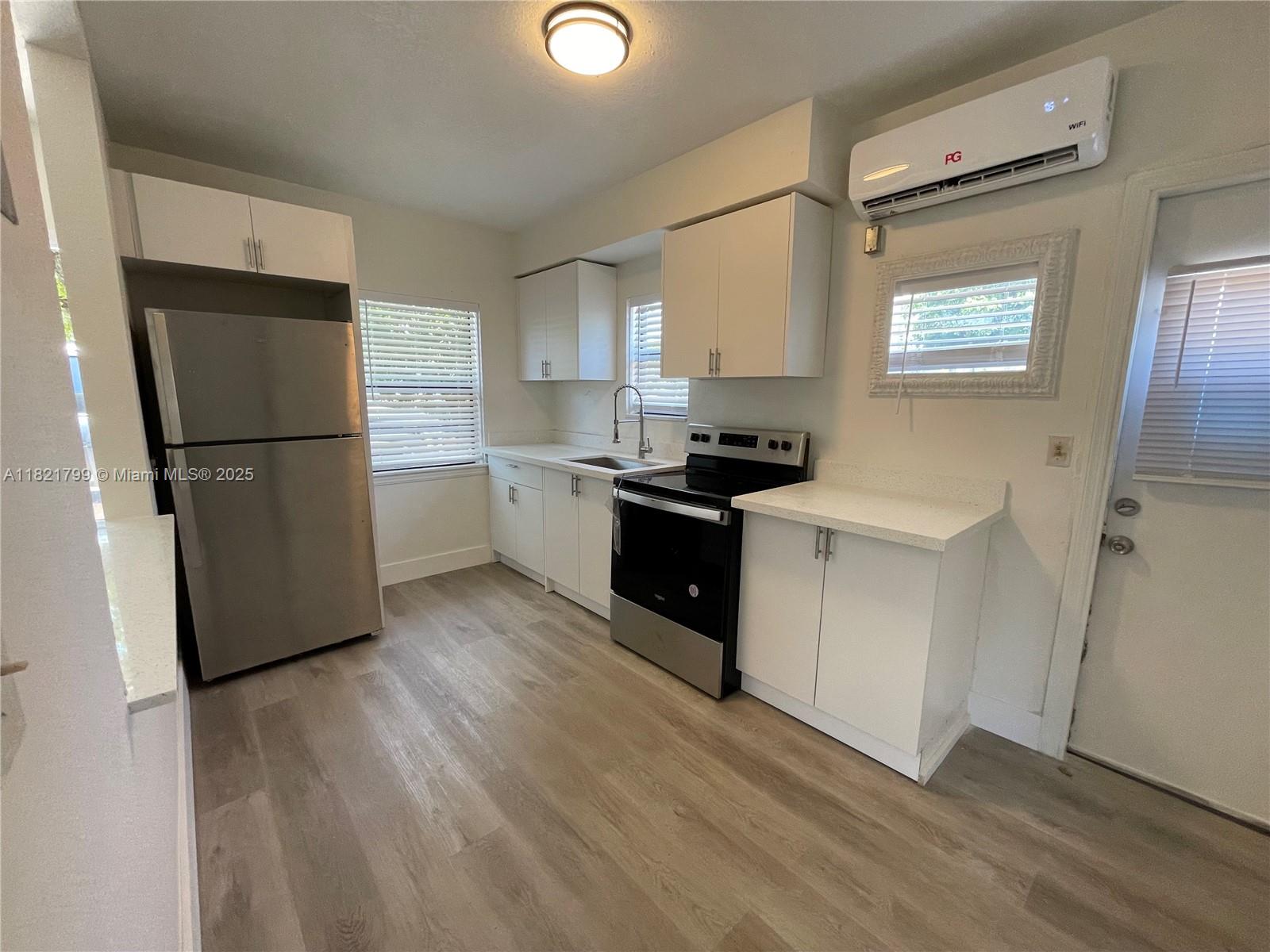 126 Northeast 19th Avenue, Unit 1 Pompano Beach, FL 33060 - Photo 3 of 7 a kitchen with a refrigerator a stove a sink dishwasher and a refrigerator