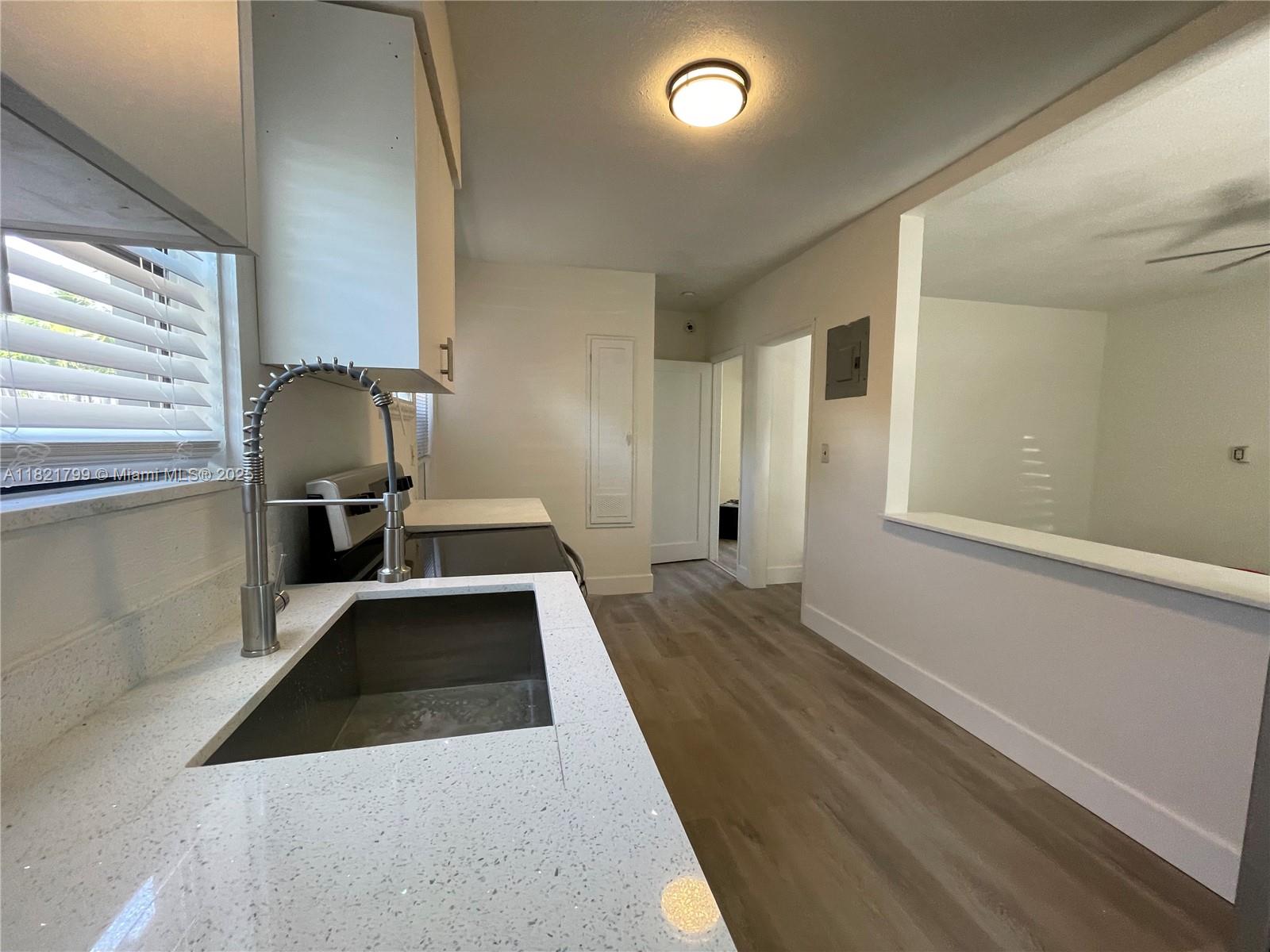 126 Northeast 19th Avenue, Unit 1 Pompano Beach, FL 33060 - Photo 4 of 7 a view of a living room and bathroom