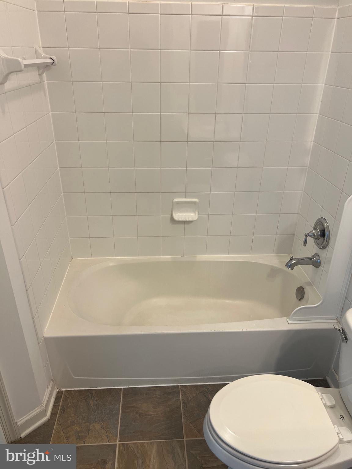 5301 Wyndholme Circle, Unit 304 Baltimore, MD 21229 - Photo 3 of 12 a bathroom with a toilet and bathtub