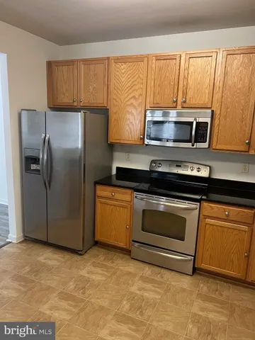 a kitchen with a refrigerator stove and microwave