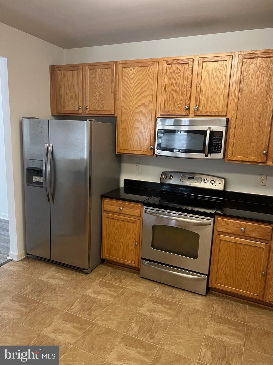 5301 Wyndholme Circle, Unit 304 Baltimore, MD 21229 - Photo 5 of 12 a kitchen with a refrigerator stove and microwave