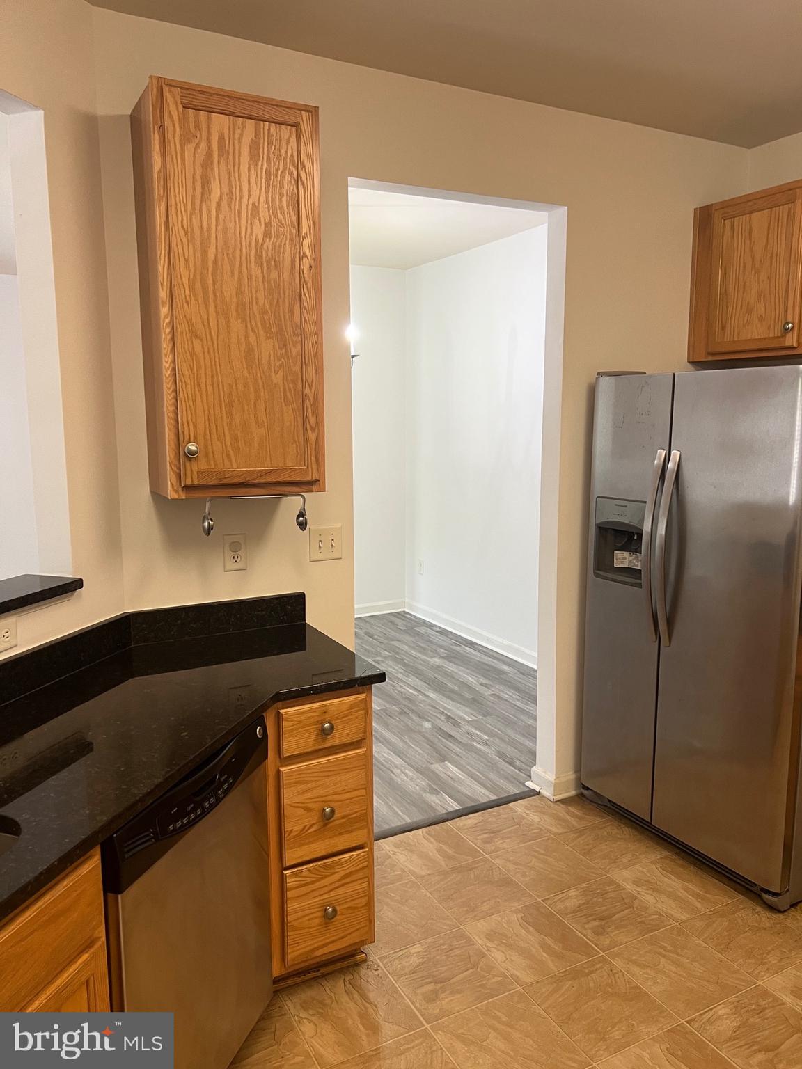 5301 Wyndholme Circle, Unit 304 Baltimore, MD 21229 - Photo 7 of 12 a kitchen with granite countertop a sink and a refrigerator