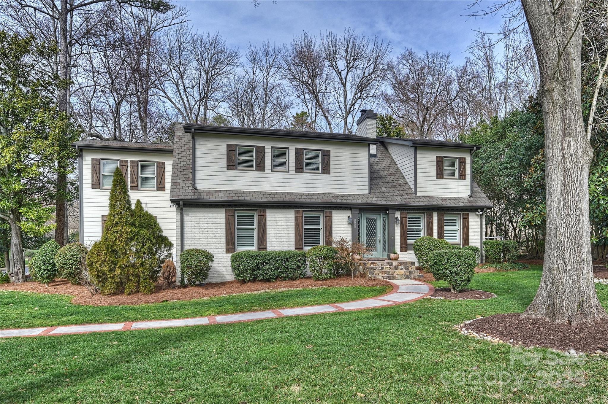830 Jefferson Drive Charlotte, NC 28270 - Photo 1 of 38 a front view of a house with a yard and trees