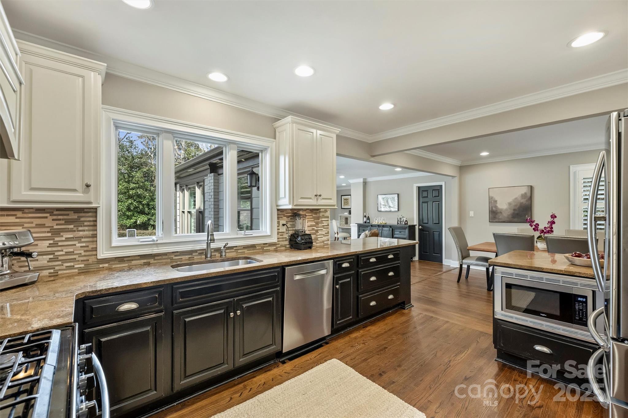 830 Jefferson Drive Charlotte, NC 28270 - Photo 11 of 38 a kitchen with stainless steel appliances granite countertop a stove a sink and a microwave