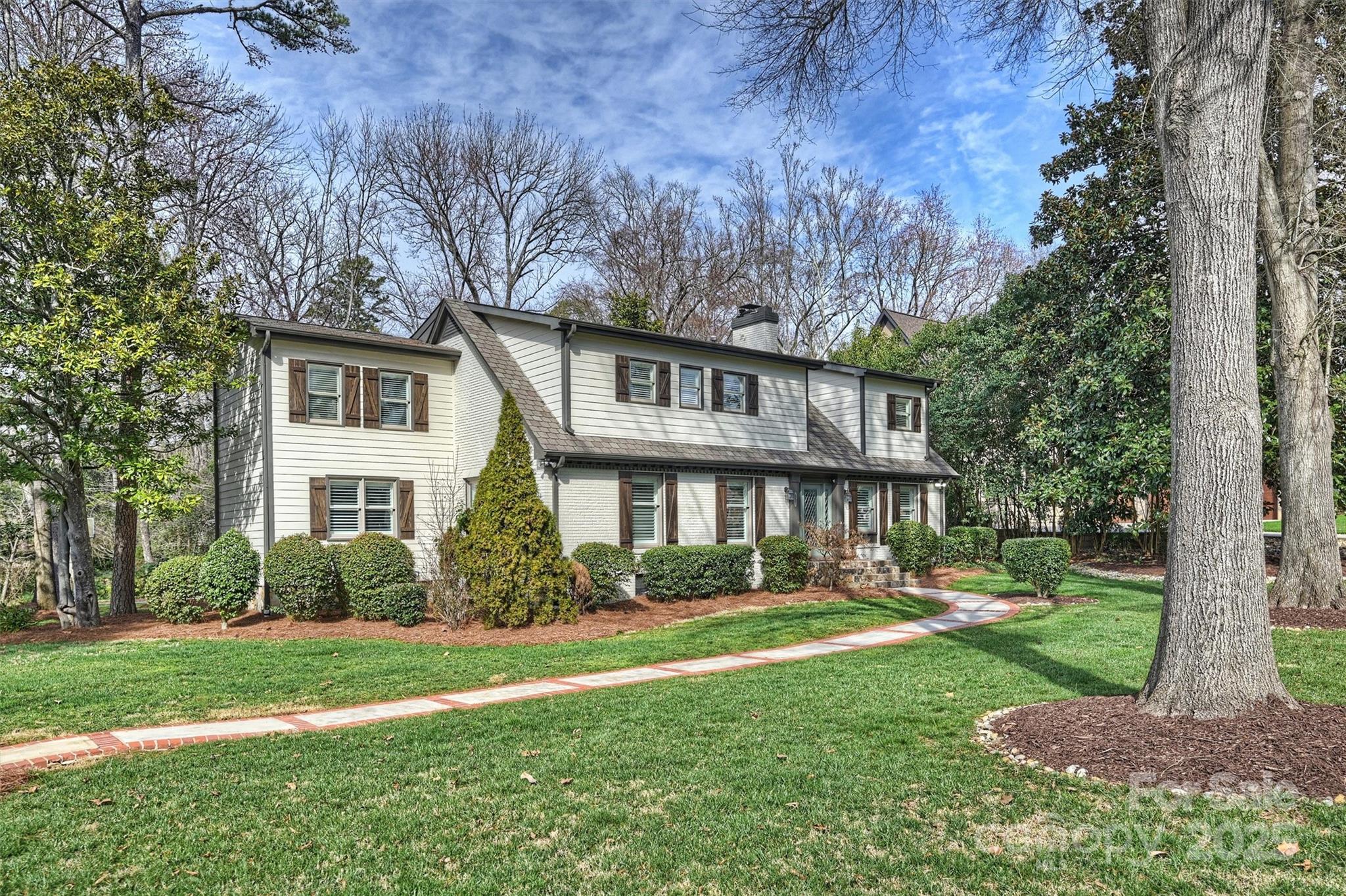 830 Jefferson Drive Charlotte, NC 28270 - Photo 2 of 38 a front view of a house with garden and trees